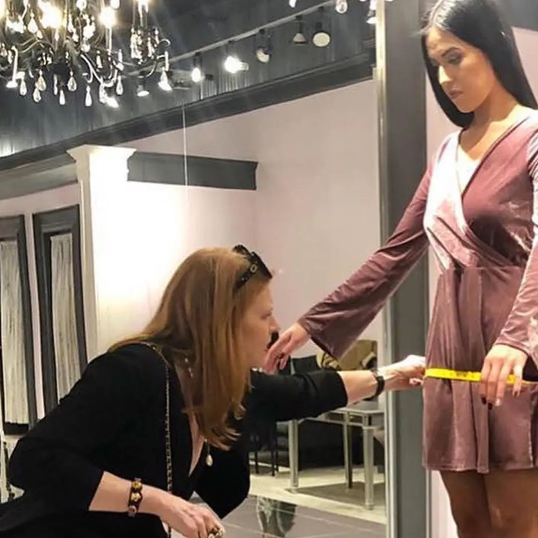 Julie DuRocher working with a model during a dress fitting