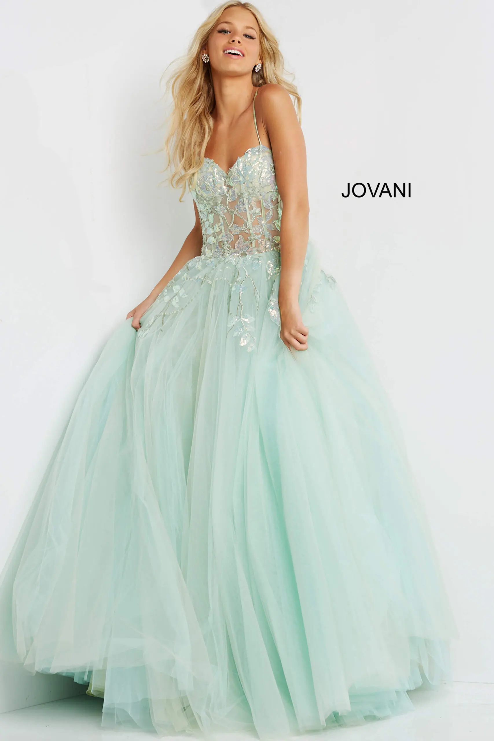 Model wearing Jovani 06816 with a sweetheart neckline and voluminous skirt in green.