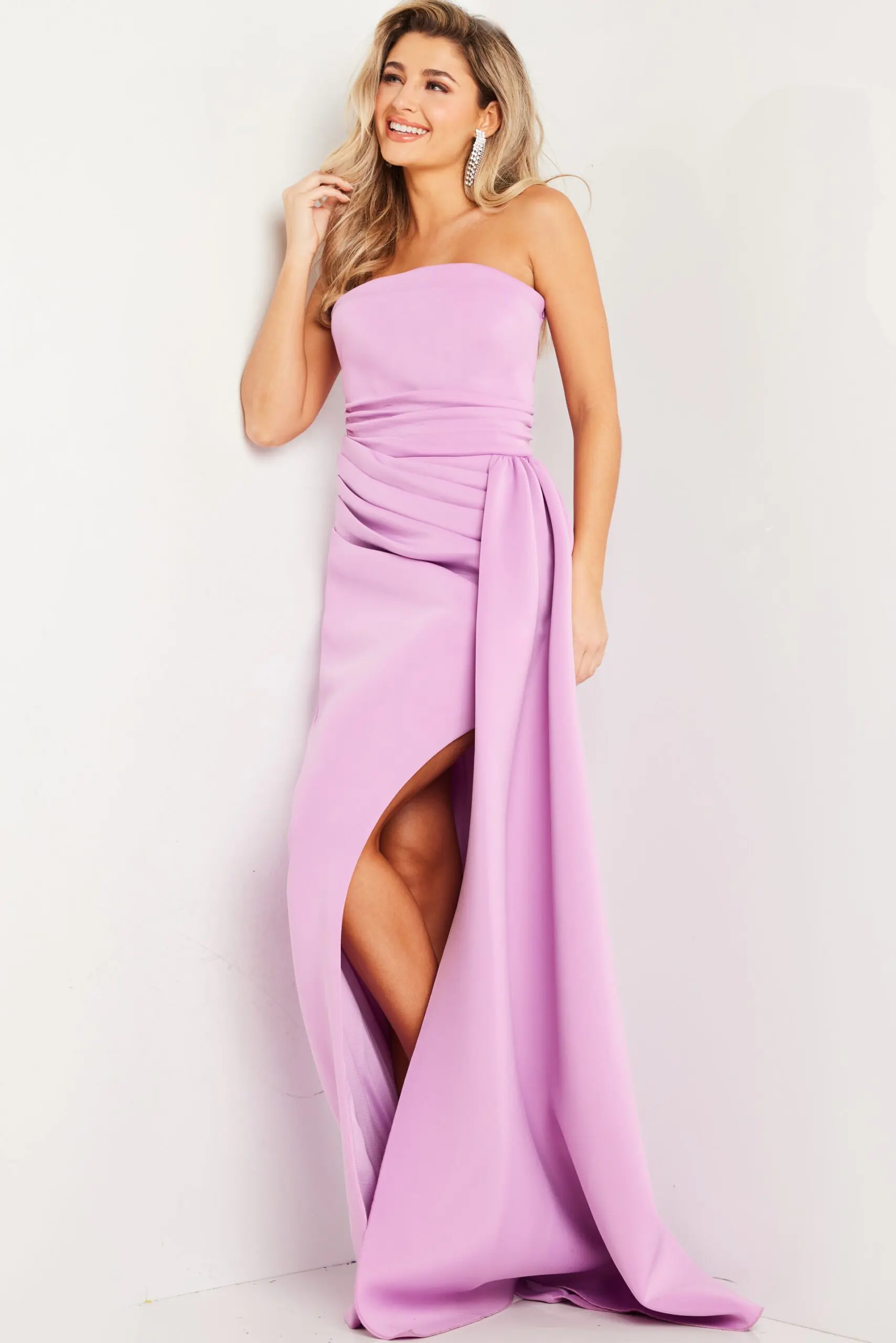 Model wearing Jovani 24012 lilac gown with strapless neckline and high slit