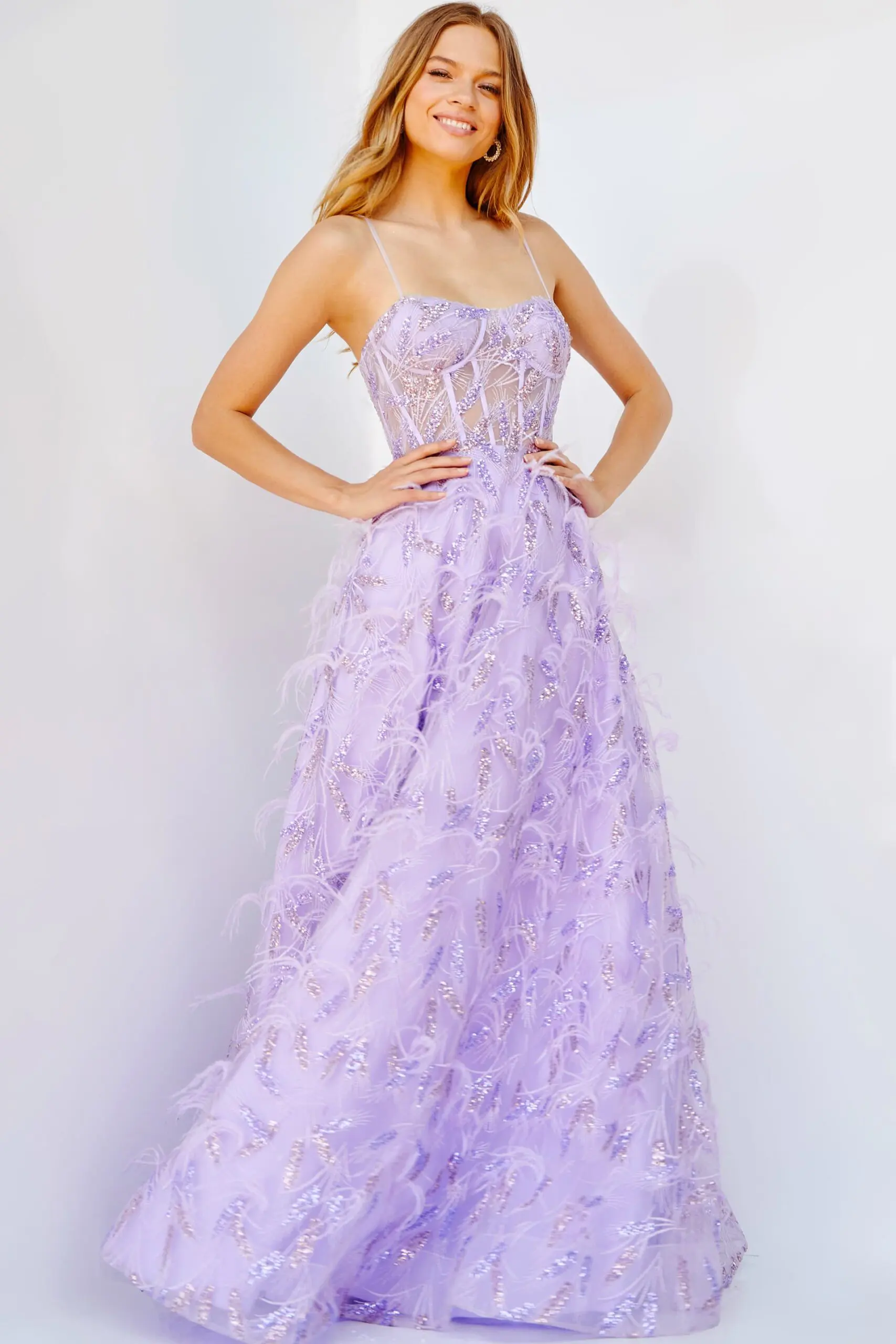 Model wearing Jovani 24078 lilac dress with a sweetheart neckline and feather embellishments from the front view.