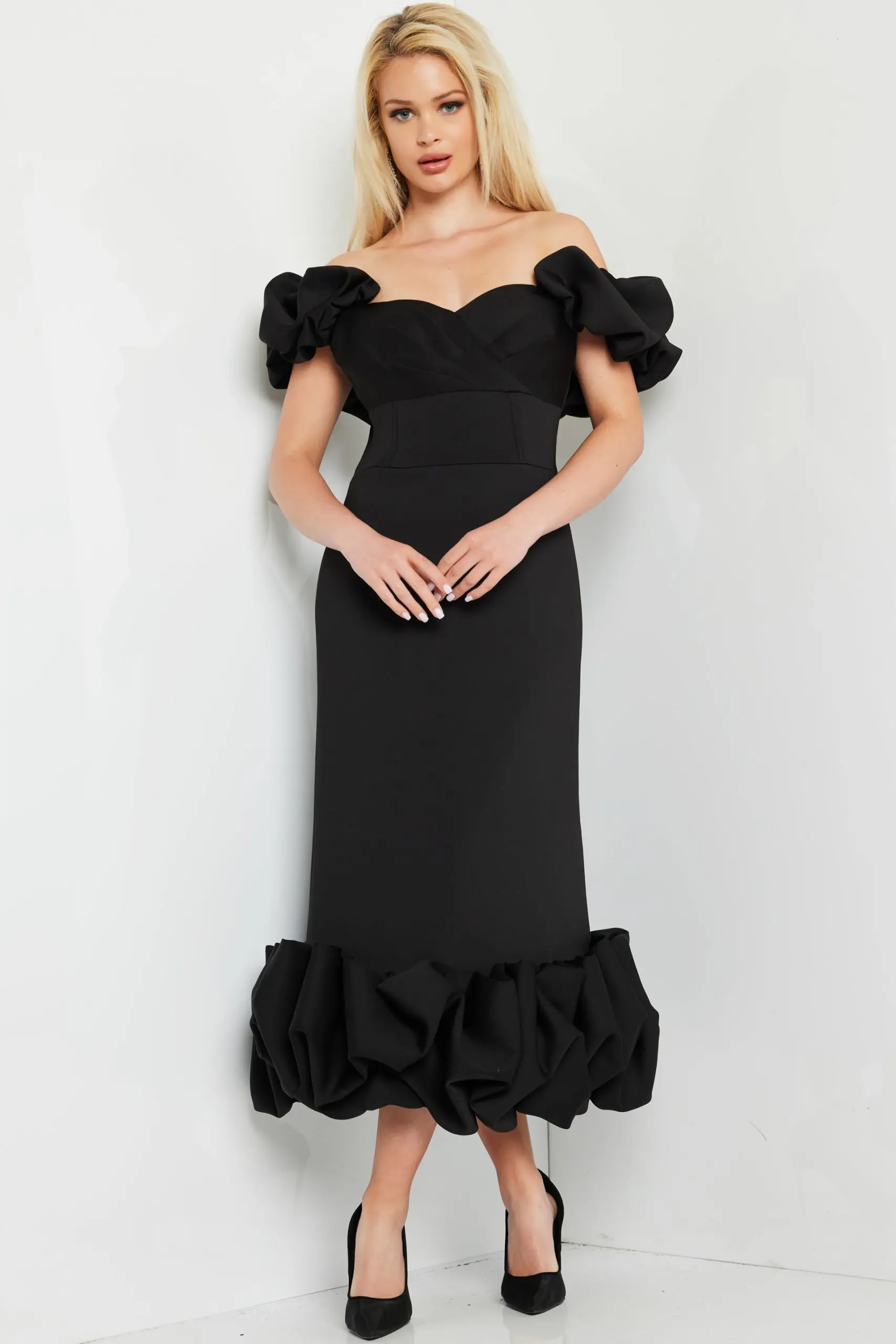 model wearing Jovani 24535 black dress with ruffled sleeves and hem, front view