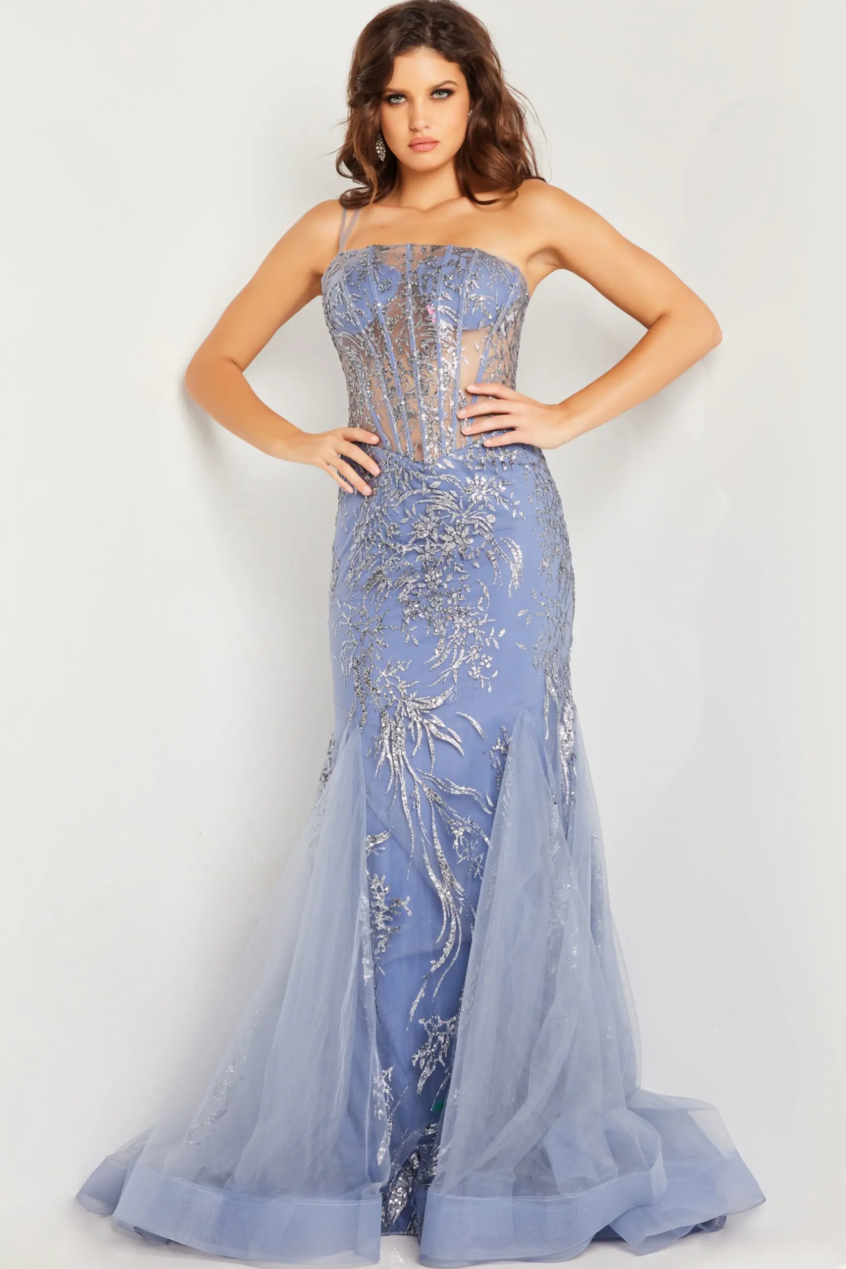Model wearing Jovani 26112 blue dress front view with floral embellishments.