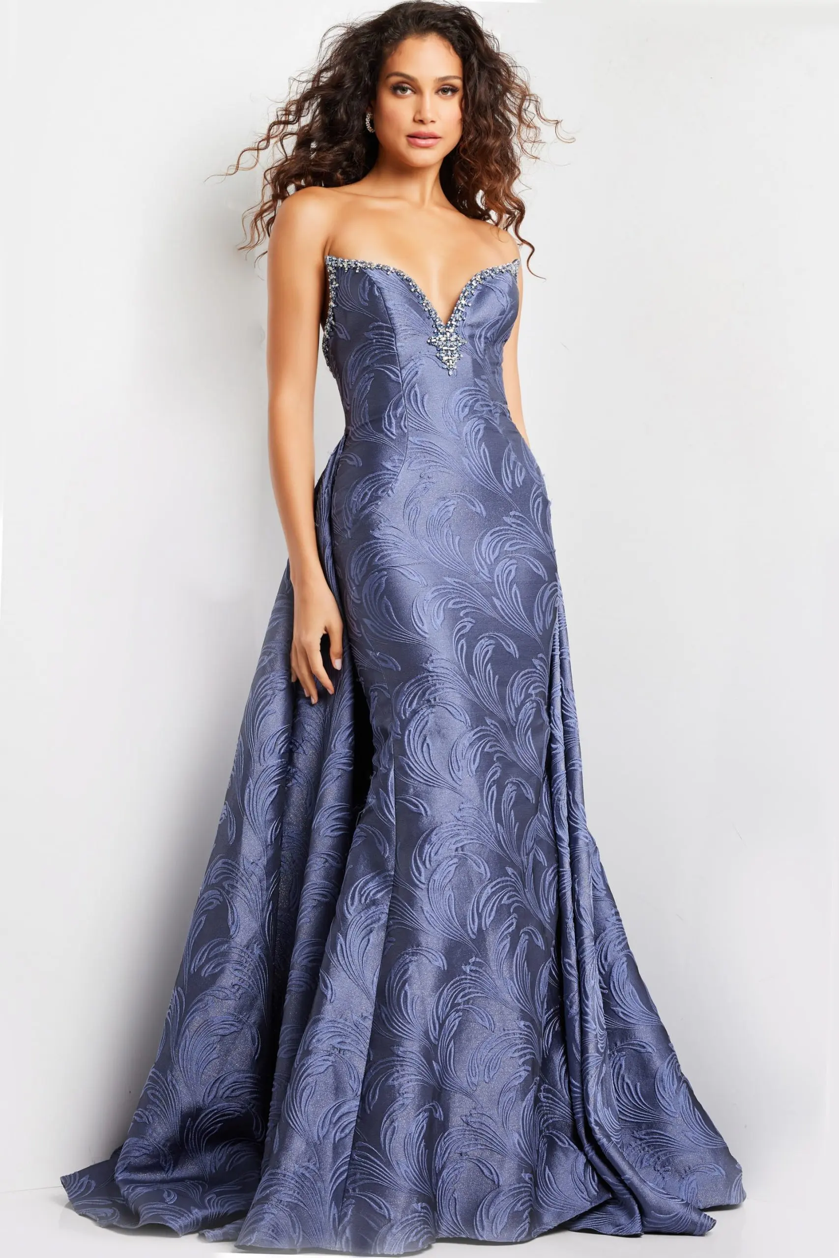 Model wearing Jovani 26115 gray gown with sleeveless design and intricate beaded detail.