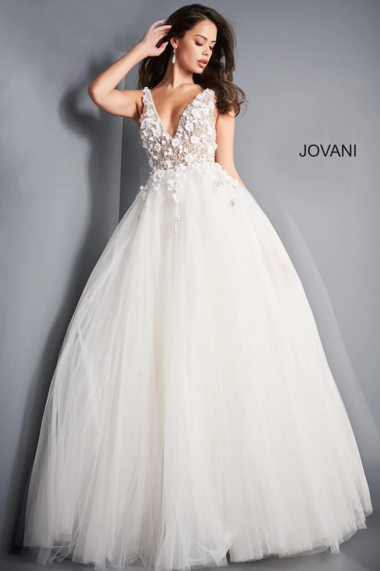 Model wearing Jovani 3110 ivory gown with floral applique and deep V-neckline, front view.