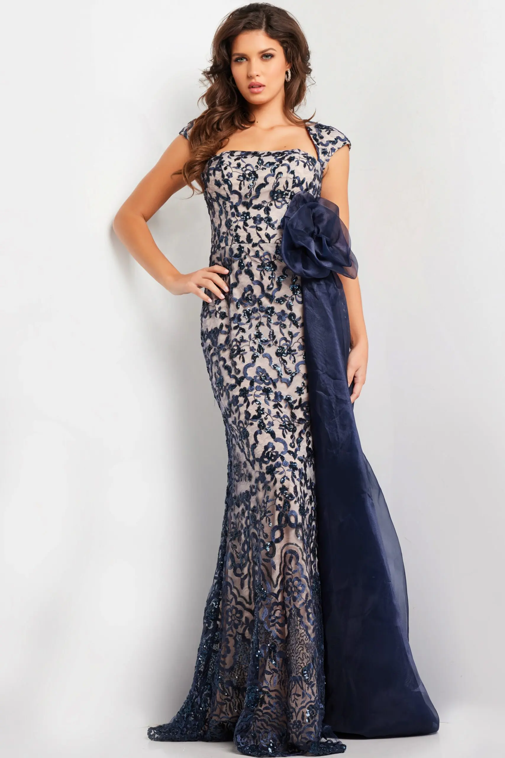 Model wearing Jovani 37203 navy dress with lace embroidery and square neckline.