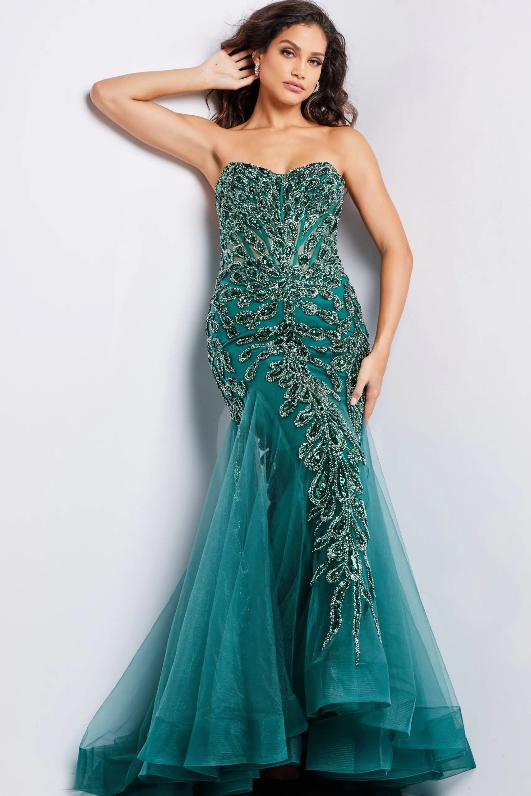 Model wearing Jovani 37412 emerald dress with intricate beadwork and tulle layers, front view.