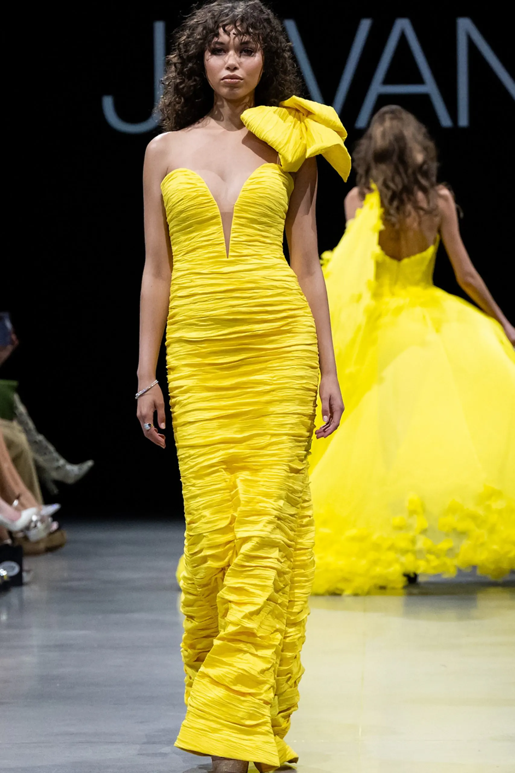 Model wearing Jovani 38240 dress with one-shoulder neckline and mermaid silhouette in yellow.