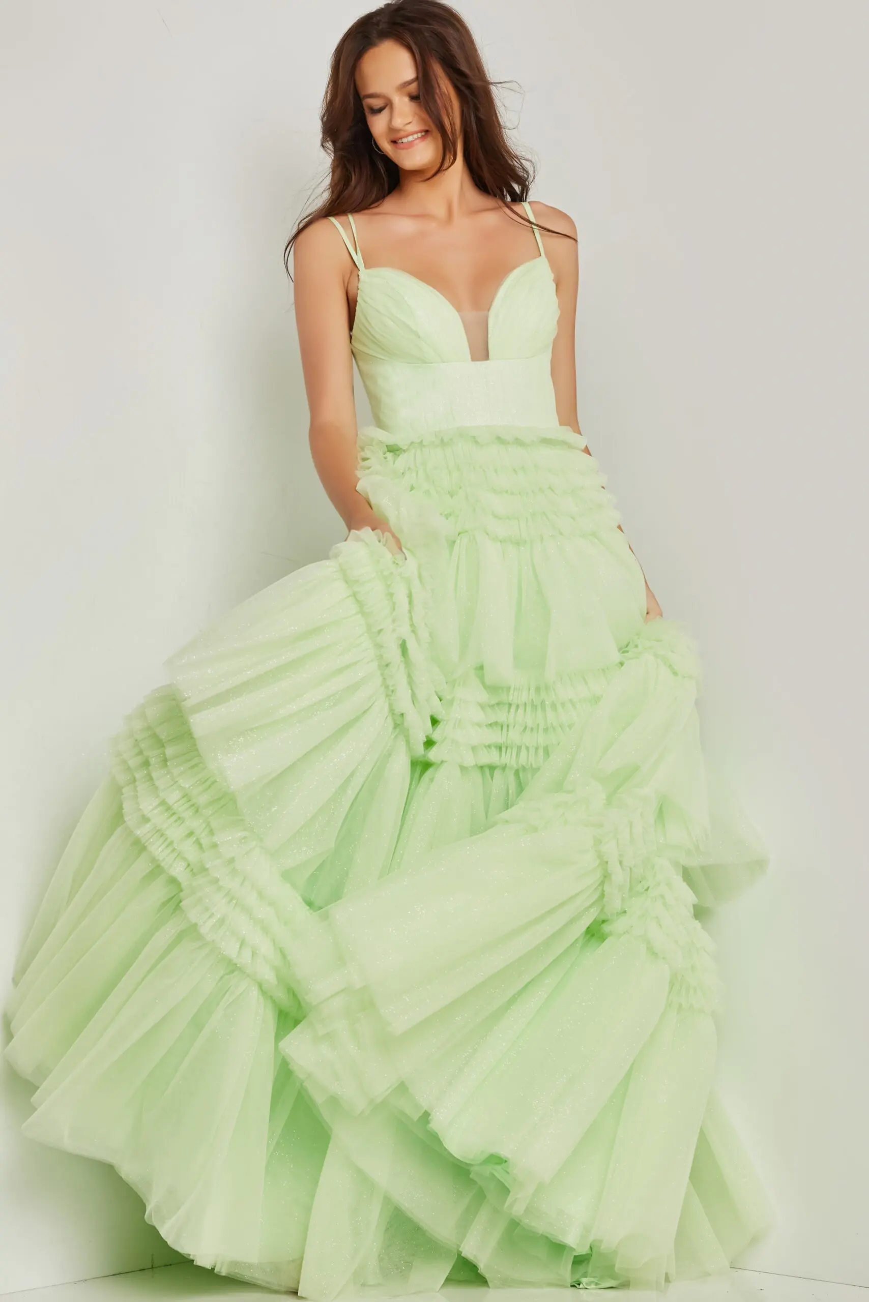 Green gown Jovani 38477 with tiered skirt and plunging neckline.