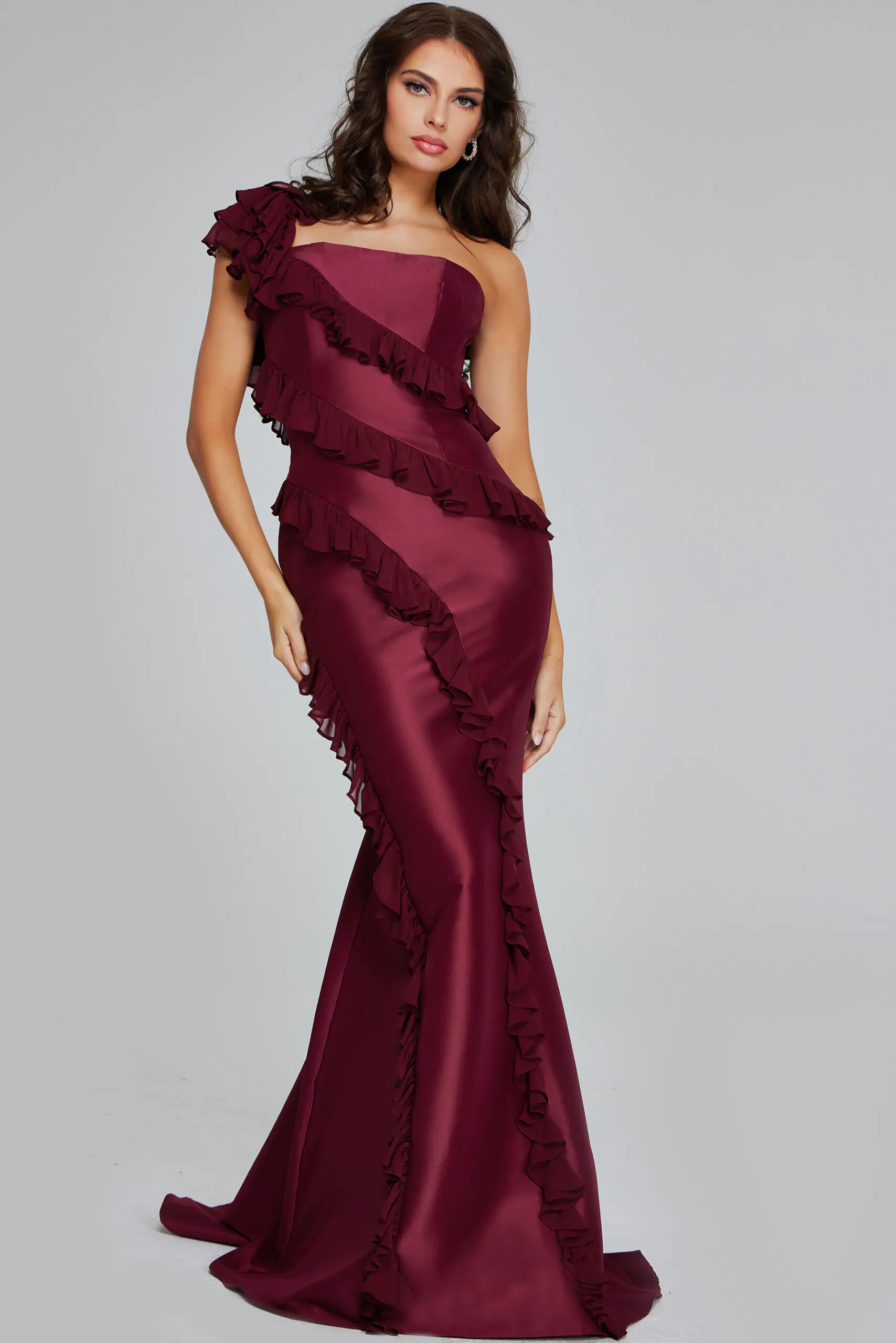 Model wearing Jovani 40751 burgundy one-shoulder gown with ruffles, front view.