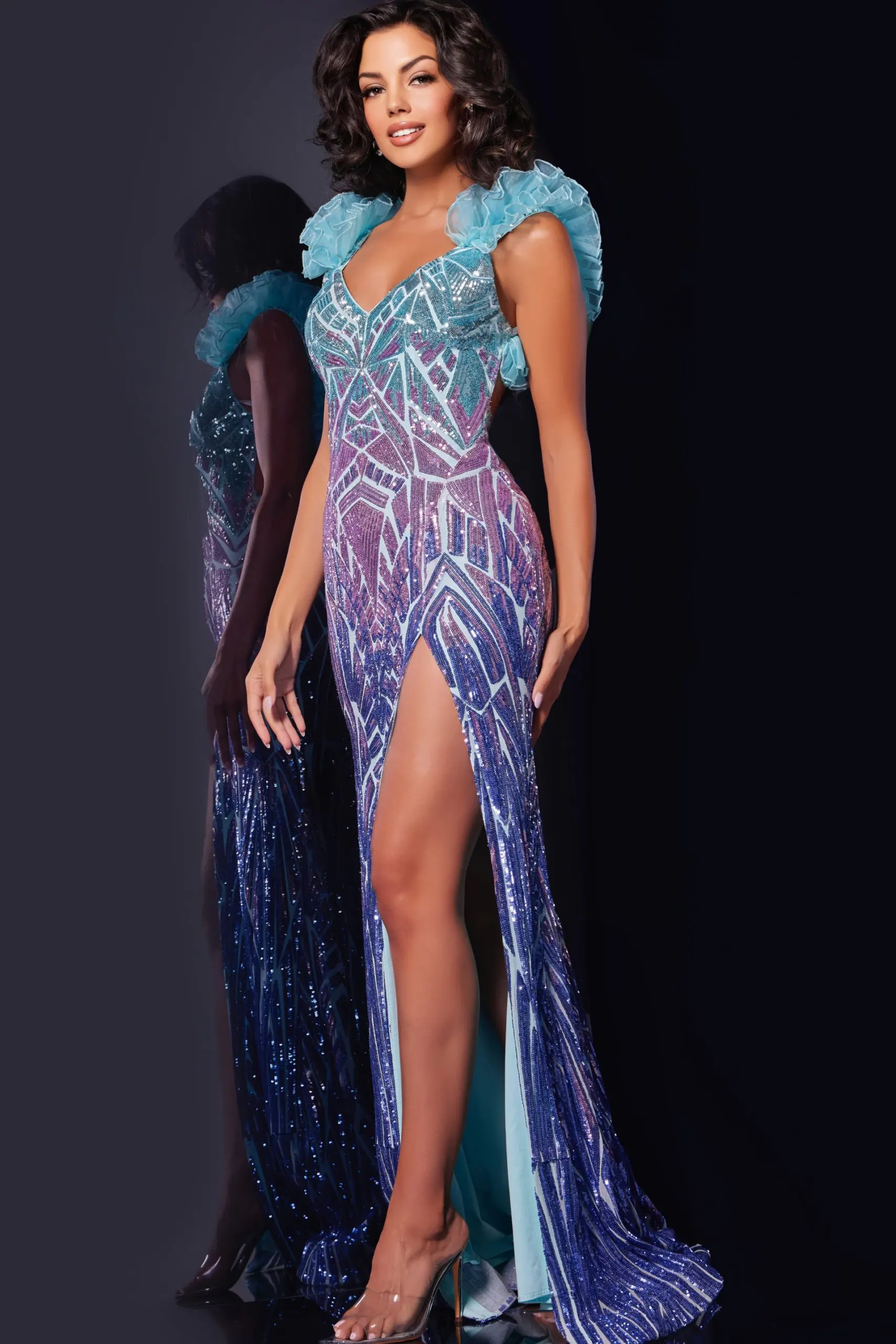 Model wearing Jovani 40761 gown with V-neckline and high slit in blue.