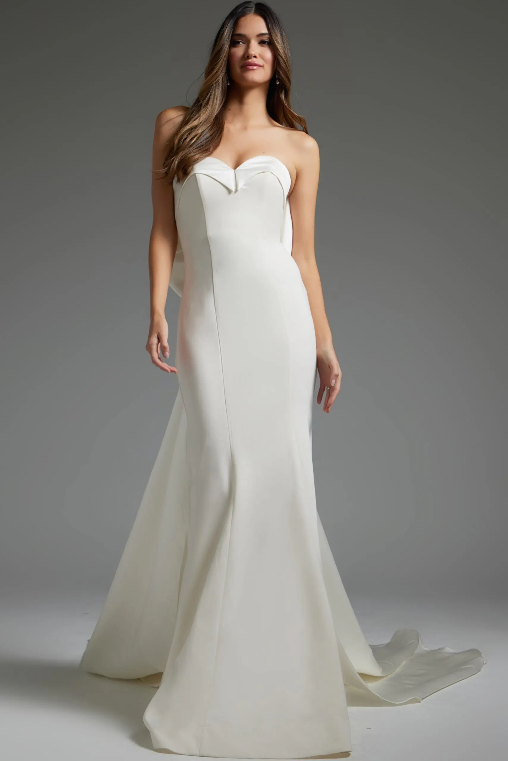 Model wearing Jovani JB05352 ivory gown with a sweetheart neckline and dramatic fit and flare design.