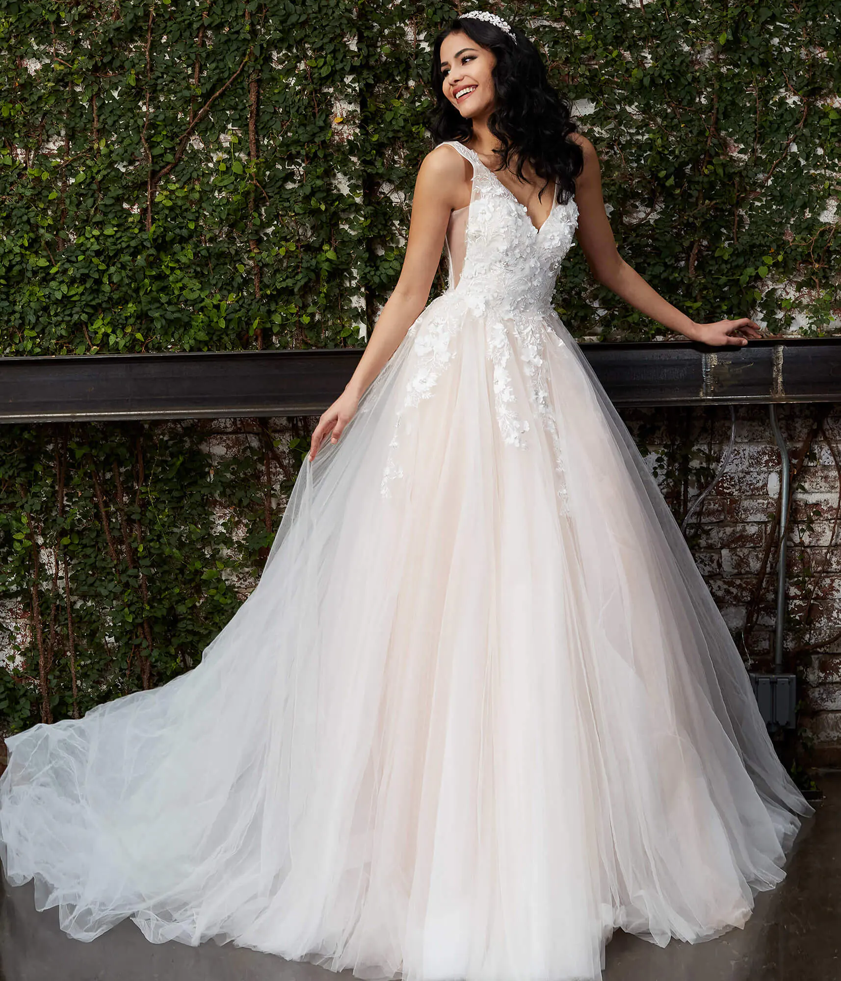 Model wearing Jovani JB05353 white gown with V-neckline and lace appliques