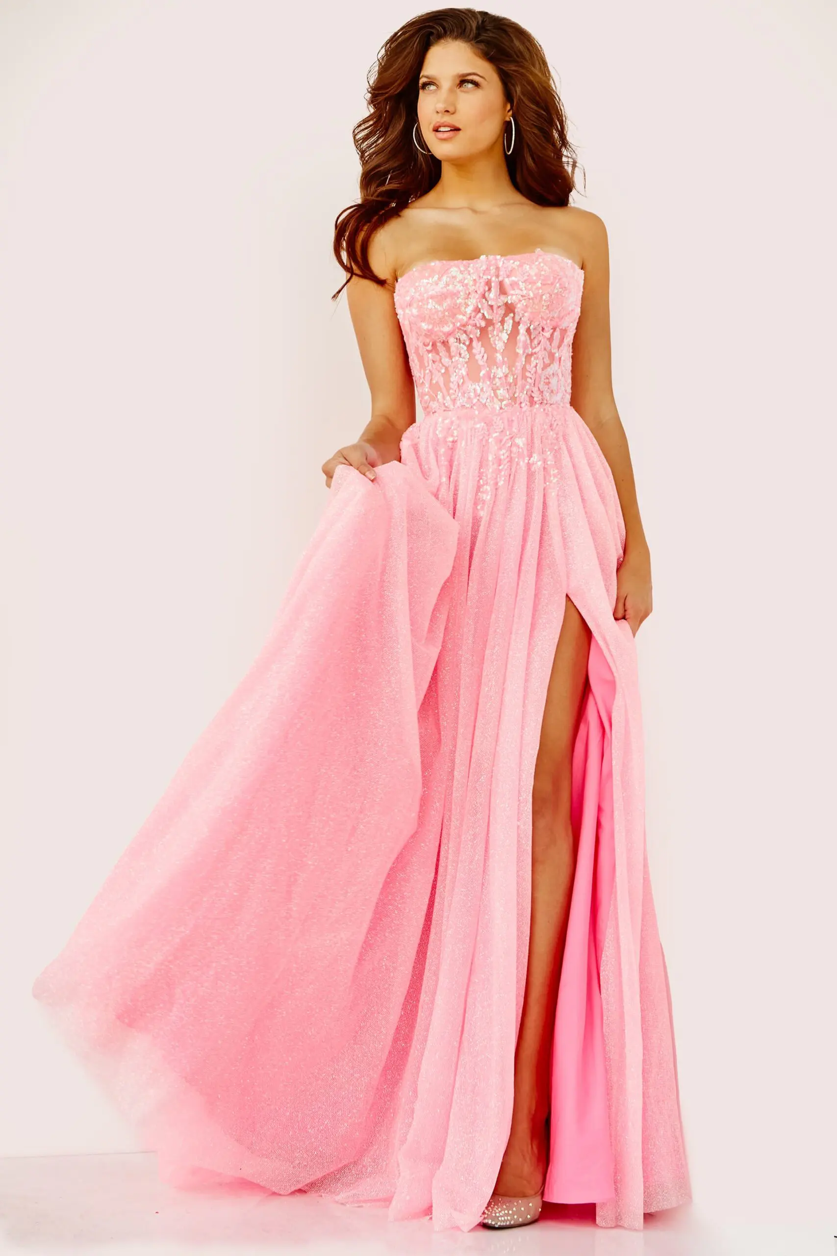 Model wearing Jovani 07434 pink gown with sweetheart neckline and high slit.
