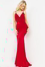 Model displaying back of Jovani 00512 burgundy dress with intricate straps.