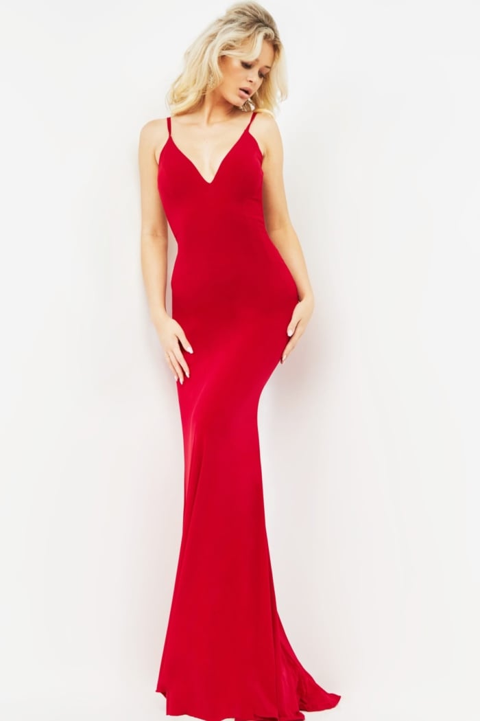 Model displaying back of Jovani 00512 burgundy dress with intricate straps.