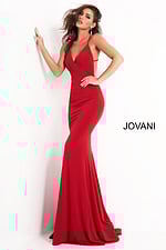 Model in Jovani 00512 red gown featuring deep V-neckline and elegant support.