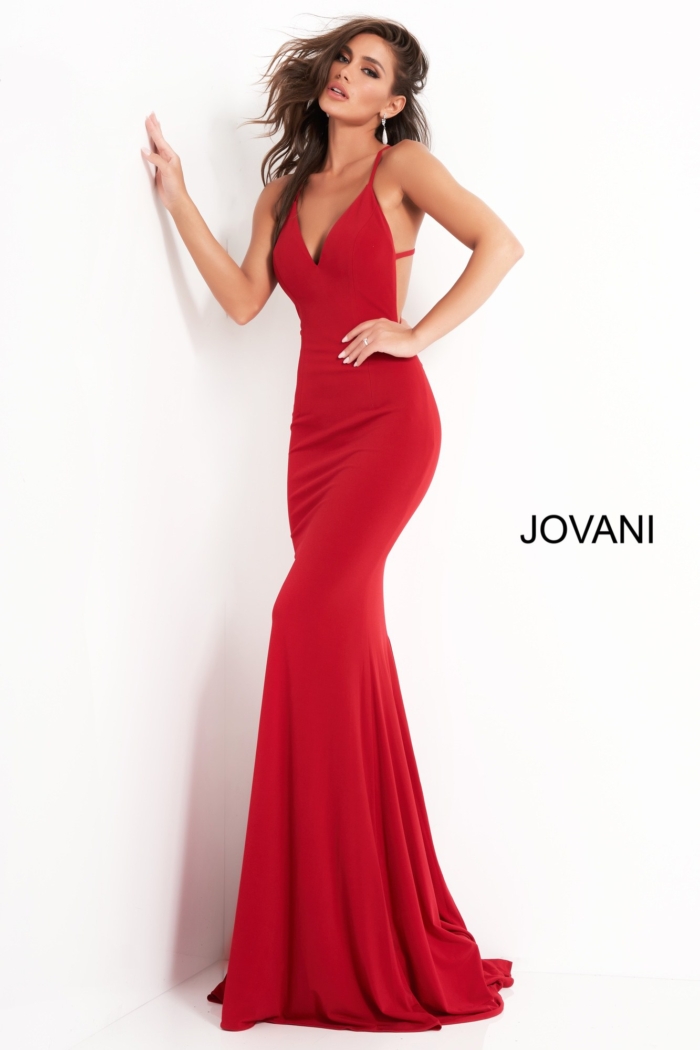 Model in Jovani 00512 red gown featuring deep V-neckline and elegant support.