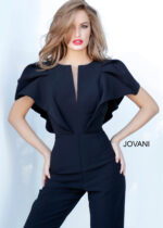 Model wearing Jovani 00762 black jumpsuit with V-neckline and flutter sleeves, front view.