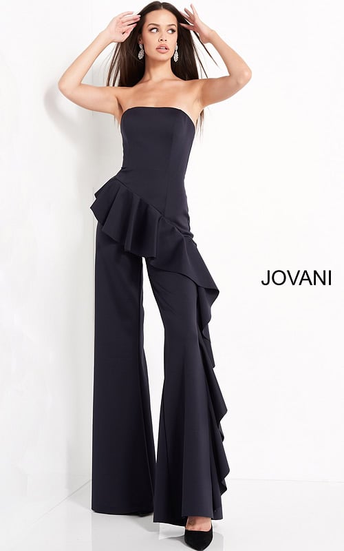Model showcasing the Jovani 00778 strapless navy jumpsuit with ruffles.