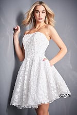 Model wearing Jovani K02564 dress in white, showcasing floral detailing and elegant silhouette.