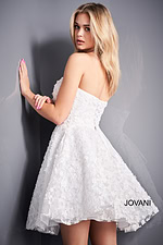 Model in white Jovani K02564 dress with floral appliqués from the back.