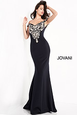 Model in Jovani 02576 navy gown, demonstrating off-the-shoulder neckline and fitted silhouette.