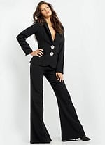 Model wearing Jovani 02637 black ensemble with deep V-neck and jeweled buttons, alternate front view.