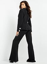 Model wearing Jovani 02637 black ensemble with deep V-neck and jeweled buttons, back view.