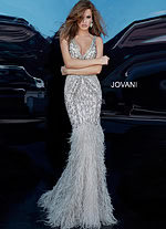 model wearing Jovani 02798 silver dress with V-neckline in elegant setting