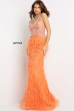 Model wearing Jovani 03023 gown in orange featuring luxurious bead and feather details.