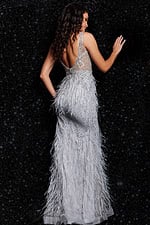 Back view of model wearing Jovani 03023 gray gown with a plunging back and decorative details.