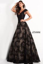 Model wearing Jovani 03330 black dress, front view with V-neckline and A-line skirt.