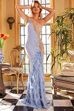 Model wearing Jovani 03389 blue gown with floral embellishments and feathers, full front view.