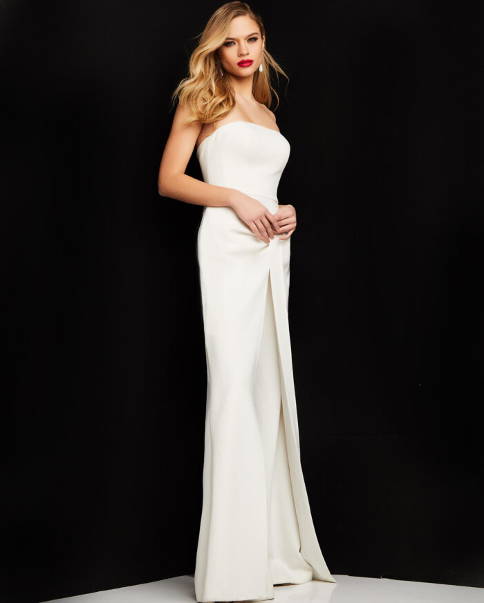 Model wearing Jovani 03828 ivory strapless jumpsuit side view highlighting fitted silhouette.