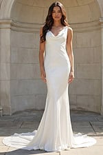 Model wearing a sleek satin gown with a draped cowl neckline and soft train.