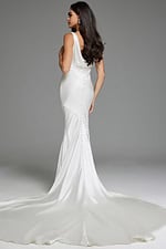 Model wearing Jovani JB03910 white dress with draped back and button detail.