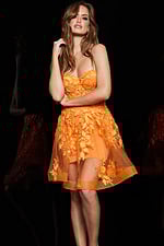 model in Jovani 04109 orange dress showing floral details, front view