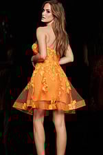 model in Jovani 04109 orange dress displaying the back design