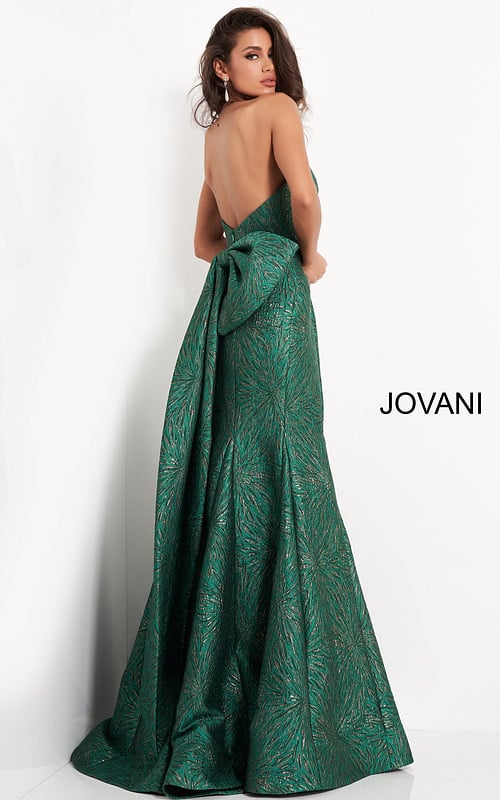 Back view of model wearing Jovani 04158 green gown with large bow accent.