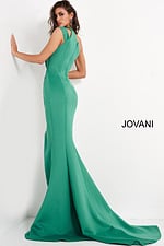 Back view of model wearing Jovani 04222 green gown with flowing hem.