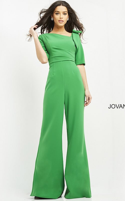 Model wearing Jovani 04284 emerald green jumpsuit with wide-leg pants and square neckline, front view.