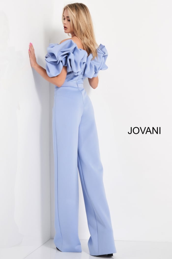 back angle of model in Jovani 04369 light blue jumpsuit with large ruffled details