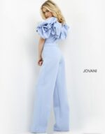Back view of model wearing Jovani 04369 light blue jumpsuit showing ruffled back detailing.