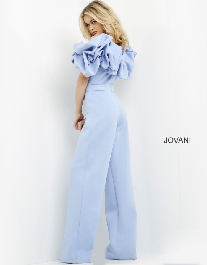 Back view of model wearing Jovani 04369 light blue jumpsuit showing ruffled back detailing.