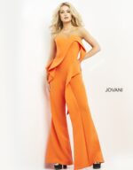 Model wearing Jovani 04427 orange jumpsuit, highlighting strapless neckline, front view