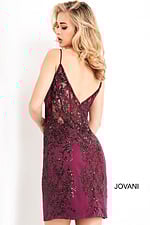 Back view of model wearing Jovani 04699 dress in purple with intricate lace detailing.