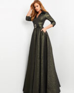 Jovani 05075 model wearing a stylish green A-line dress with a V-neckline and belt detail.