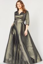Model in Jovani 05075 green dress, featuring an A-line silhouette and elegant three-quarter sleeves.