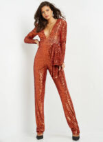 Model in Jovani 05345 orange sequin jumpsuit featuring deep V-neckline, front view.