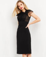 Model wearing Jovani 05674 black dress with sheer lace overlay, front view.